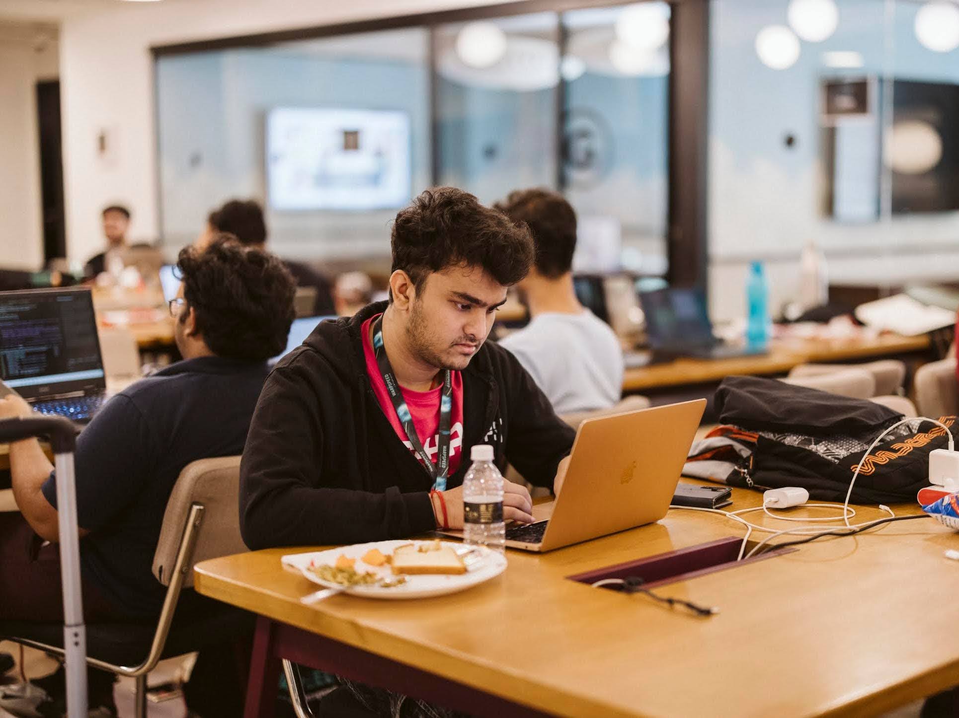 A person sitting at a desk in front of a computer